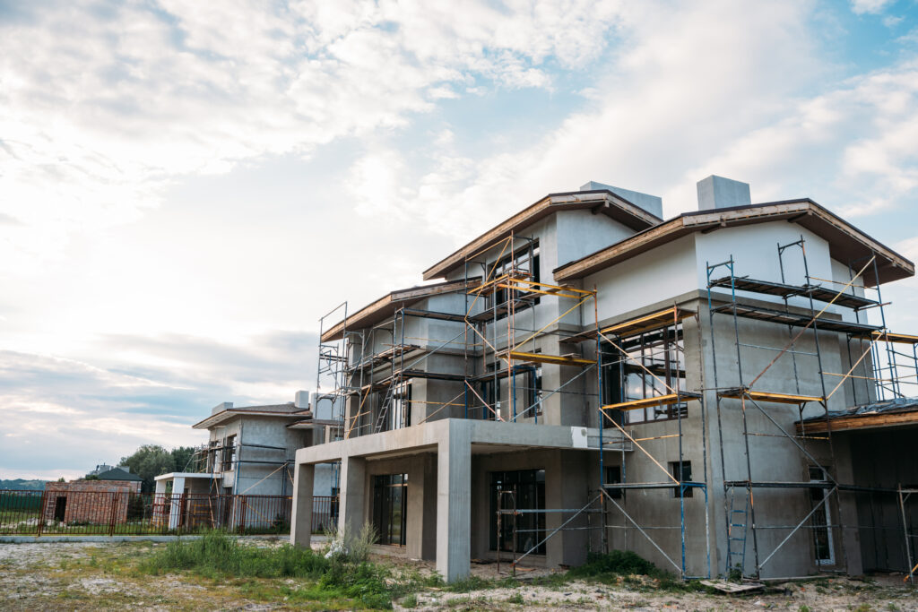 contemporary building construction with scaffolding under cloudy sky